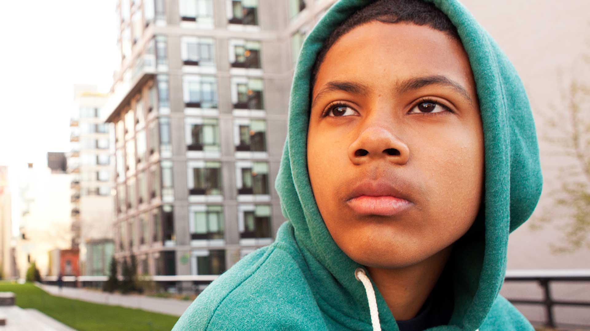 Portrait of boy in a hoodie looking contemplatively